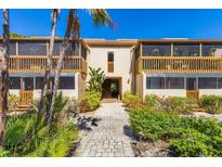 Inviting condo exterior with lush landscaping and a charming walkway to the front entry at 3073 Willow Grn # 36, Sarasota, FL 34235
