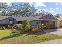 Charming single-story home features a two-car garage, well-manicured lawn, and lush landscaping at 604 68Th Avenue W Dr, Bradenton, FL 34207