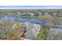 Beautiful home with a screened-in lanai overlooking a tranquil lake, enhancing outdoor living at 11910 Soft Rush Ter, Lakewood Ranch, FL 34202