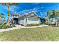 Beautiful single-Gathering home featuring a two-car garage and meticulously landscaped front yard at 260 Van Gogh Cv, Bradenton, FL 34212