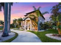 Stunning two-story home showcasing lush landscaping, and a circular driveway at 310 79Th Nw St, Bradenton, FL 34209