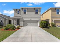 Charming two-story home featuring a manicured lawn and a spacious two-car garage at 4205 Willow Hammock Dr, Palmetto, FL 34221