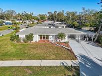 Charming single story home featuring a well-maintained lawn, covered parking and freshly painted exterior at 4335 Maceachen Blvd, Sarasota, FL 34233