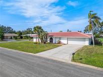 Charming single Gathering home with a well manicured lawn, a concrete driveway, and a red tile roof at 441 Rubens E Dr, Nokomis, FL 34275