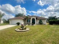 Charming single-story home with a well-manicured lawn and inviting front entrance at 503 Philodendron, Punta Gorda, FL 33955