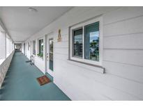 Inviting condo featuring a cozy entryway with a decorative pineapple and a well-lit corridor at 5892 17Th W St # C25, Bradenton, FL 34207