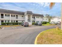 Exterior view of a two-story condo building with ample parking at 102 46Th Avenue W Ter # 402, Bradenton, FL 34207