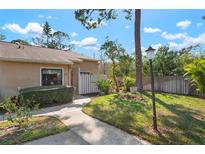 Inviting single-story home featuring a well-maintained lawn, garden bed and sidewalk leading to the front entrance at 3296 Tallywood Ct # 7097, Sarasota, FL 34237