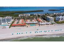 Breathtaking aerial view of oceanfront condos with a pristine beach and clear blue waters at 4621 Gulf Of Mexico Dr # 19B, Longboat Key, FL 34228