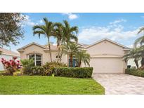 Charming single-story home featuring a paver driveway, lush landscaping, and a two-car garage at 5112 52Nd W Ave, Bradenton, FL 34210