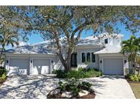 Stunning single-story home with a three-car garage and meticulously maintained landscaping at 5169 Sandy Shore Ave, Sarasota, FL 34242