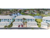 Beautiful condo community with water view and attached garages and palm trees at 5743 Sabal Trace Dr # 101B57, North Port, FL 34287