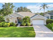 Charming single-story home with lush landscaping and a well-manicured lawn at 10306 Palmbrooke Ter, Bradenton, FL 34202
