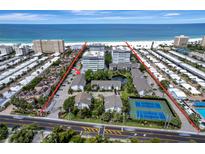 Beautiful beachfront community featuring lush landscaping, tennis courts, and a pristine view of the ocean at 1141 W Peppertree Dr # 1141, Sarasota, FL 34242