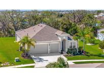 Charming single-story home featuring a three-car garage, well-maintained landscaping, and a picturesque setting at 12809 Rainwashed Loop, Parrish, FL 34219