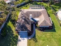 An aerial view of a beautiful home with a well maintained lawn, a pool, and a brick chimney at 1838 Sandalwood Dr, Sarasota, FL 34231