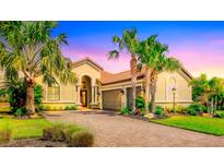 Stunning single-story home featuring a tile roof, mature landscaping, and a paver driveway at 4719 Cabreo Ct, Bradenton, FL 34211