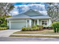 Charming single-story home featuring a two-car garage, lovely landscaping, and a cozy front porch at 4907 Torrey Pines Run, Bradenton, FL 34211