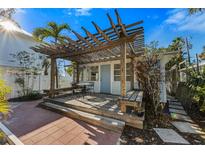 Charming outdoor deck featuring a pergola, seating, and a quaint outdoor space at 520 Spring Ave # A, Anna Maria, FL 34216