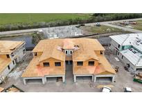 Aerial view of a new home being built, featuring its roof, foundation, and spacious layout in a developing neighborhood at 5628 Summit Point Cir # 103, Bradenton, FL 34210