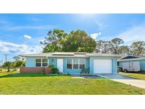 Charming blue single-story home with a well-maintained lawn and a one-car garage at 8003 Herbison Ave, North Port, FL 34287