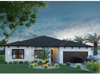 Inviting one-story home showcasing a two-car garage and professionally manicured front yard at 16733 Carmine Rd, Venice, FL 34293
