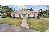 Charming single story home with manicured lawn and inviting walkway leading to the front door at 2 Antigua Cir # 4, Englewood, FL 34223