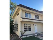 Charming two-story townhouse with neutral stucco, multi-pane windows and well-lit entry at 216 Amherst Ave # 97, Sarasota, FL 34232