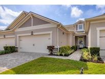 Charming single-story home with a well-manicured lawn, brick driveway and two-car garage at 3645 Tin Cup Blvd, Sarasota, FL 34232