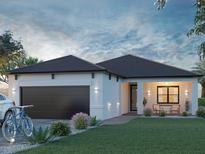 Charming single-story home with a two-car garage, inviting front porch, and well-maintained landscaping at 5 Varden Ter, North Port, FL 34288