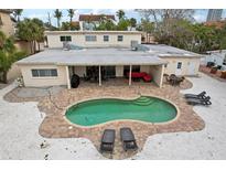 Backyard oasis with a kidney shaped pool, outdoor seating and patio area at 55 N Washington Dr, Sarasota, FL 34236