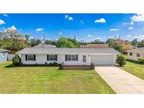Charming single-story home with a well-manicured lawn and an attached one-car garage at 6349 5Th Street E Cir, Bradenton, FL 34203