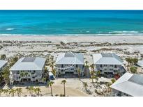 Stunning aerial view of beachfront homes with Gulf views and white sandy beach access at 7490 Palm Island Dr # 2324, Placida, FL 33946