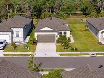 Beautiful single-story home featuring a neatly maintained lawn and a neutral color palette at 8619 Firefly Pl, Parrish, FL 34219
