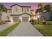 Beautiful two-story home featuring a well-manicured lawn, neutral colored paint and two car garage at 15147 Sunny Day Dr, Bradenton, FL 34211