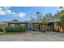 Charming single-story home with a bright blue front door and meticulously maintained landscaping at 2130 Temple St, Sarasota, FL 34239