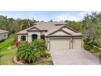 Beautiful home featuring a lush front yard, multi-car garage, neutral paint, and a tile roof at 2515 130Th E Ave, Parrish, FL 34219