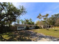 Charming single-story home with a welcoming front porch and mature landscaping at 2696 Loma Linda St, Sarasota, FL 34239