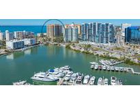 Stunning aerial view of the residences, showcasing waterfront access and marina with luxurious yachts at 35 Watergate Dr # 1101, Sarasota, FL 34236