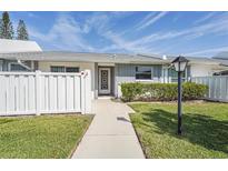 Charming condo featuring a well-maintained front yard with vibrant green grass and a tidy garden bed at 3902 36Th Avenue W Dr, Bradenton, FL 34205