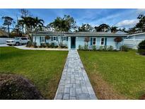 Charming single-story home with a landscaped front yard, stone walkway, and inviting curb appeal at 4218 S Lockwood Ridge Rd, Sarasota, FL 34231