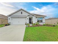 Charming single-story home featuring a manicured lawn and a two-car garage at 4411 Hearthstone Run, Palmetto, FL 34221