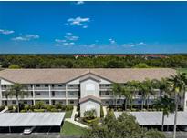 Beautiful condominium with meticulously maintained landscaping and carport parking at 8735 Olde Hickory Ave # 8303, Sarasota, FL 34238