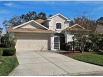 Charming two-story home with a well-manicured lawn, complemented by a two-car garage and traditional design at 1155 Millbrook Cir, Bradenton, FL 34212