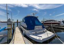 View of a well-maintained, covered yacht docked at a pier, with a serene waterfront view at 1318 3Rd Street E Cir, Palmetto, FL 34221
