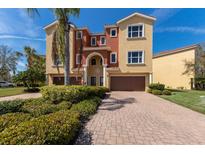 Inviting multi-story home with lush landscaping, two-car garage, and charming curb appeal at 1318 3Rd Street E Cir, Palmetto, FL 34221