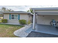 Charming single-story home with a carport, tidy landscaping, and light-colored exterior at 14 Strathmore Blvd # 14, Sarasota, FL 34233