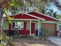 Charming, single-story home with green and red exterior and a well-maintained front yard at 1782 Mississippi Ne Ave, St Petersburg, FL 33703