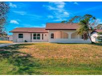 Charming single-story home boasts a well-manicured lawn and classic architectural details at 3389 Dunbar St, Port Charlotte, FL 33948