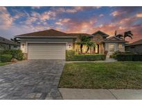 Beautiful single-story home features a well-manicured lawn, stone accents, and a spacious two-car garage at 368 Snapdragon Loop, Bradenton, FL 34212